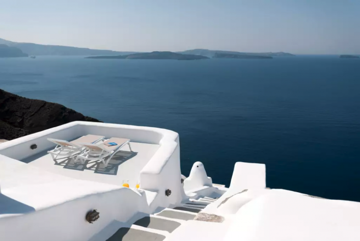 Der Ausblick über die weiße Terrasse und die hellen Wege des Ortes über das Meer.