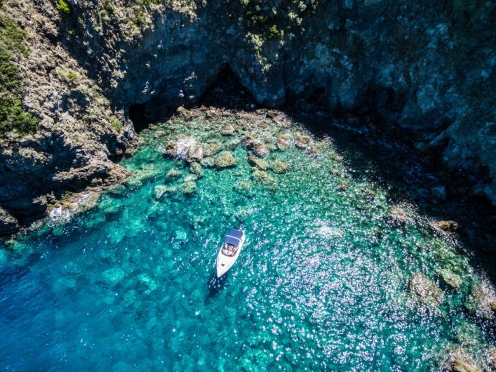 ischia-lonely-boat-in-a-turquoise-naples-italyshutterstock_469607711_900x600