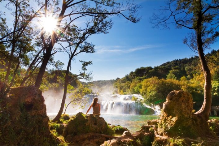 woman-waterfall-Krka-national-park_iStock-175730028_900x600